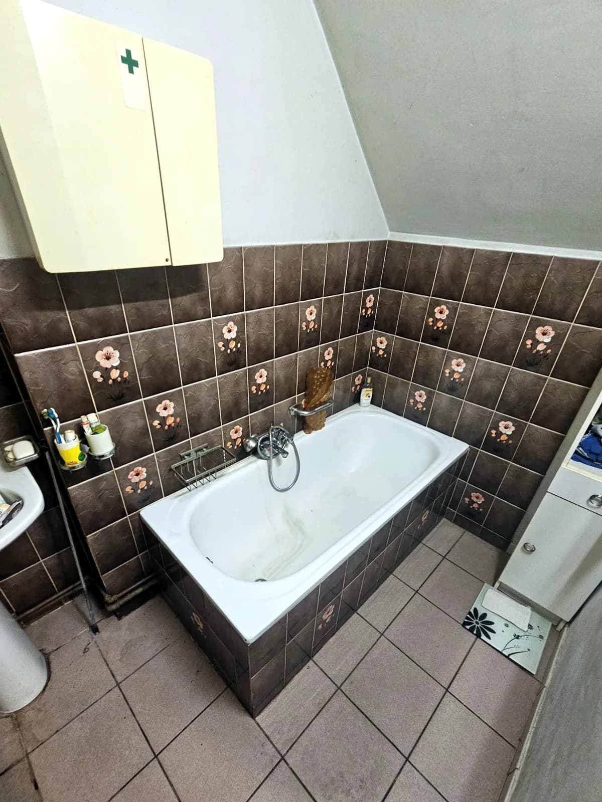 Shower with a fold-down seat and grab rails, before the work