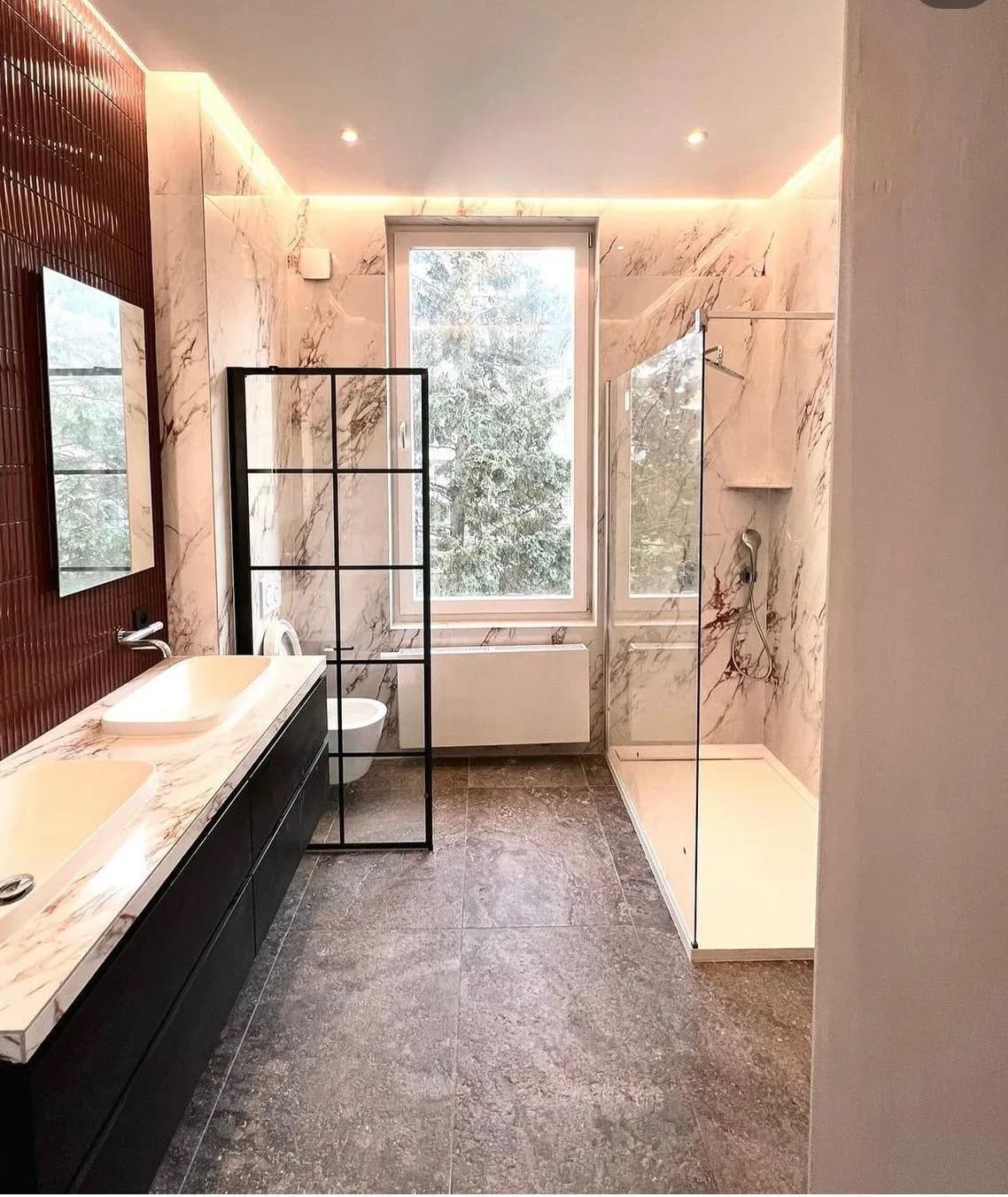 Complete marble bathroom with a double basin and a walk-in shower
